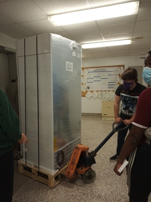 Grads students moving fridge